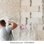machine-plastering-applying-gypsum-plaster-260nw-2353786815